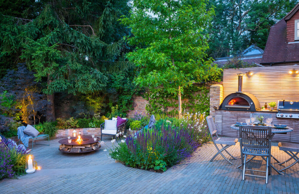 An extension of home: Scented plants, an outdoor kitchen and sunken firepit seating area have transformed this underused Surrey plot into a welcoming space for outdoor living.